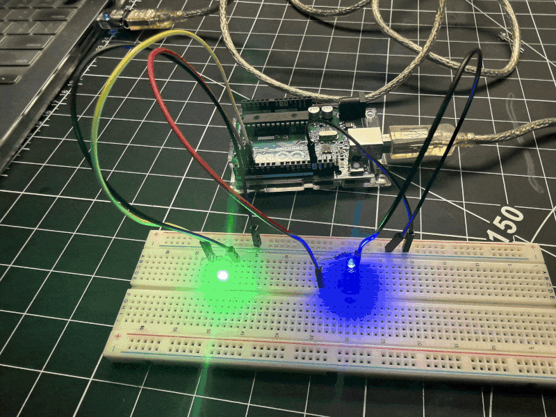 Expanding the circuit with multiple LEDs on the breadboard. The green and blue LEDs are blinking together.